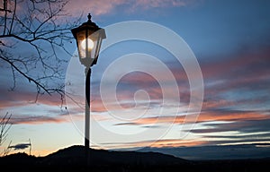 Old lamp post in sunset sky