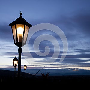 Old lamp post in sunset sky