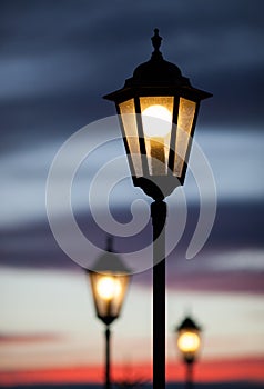 Old lamp post in sunset sky