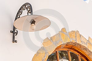 Old lamp on the white stone wall