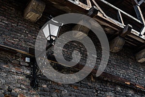 Old lantern on the stoned wall of ancient castle