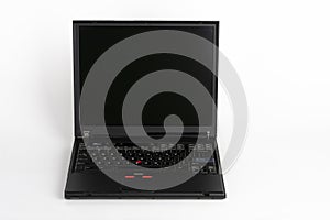 Old laptop on white background, which was produced in 2003, diagonal screen size 14 inches, outer cover reinforced titanium, metal