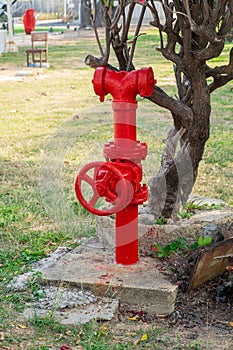 An old, large vintage red fire hydrant in the field