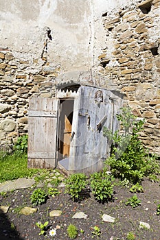 Old latrine building in the back of a old house photo