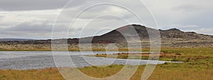 Volcanic landscape and pond in Vesturland, Iceland. photo