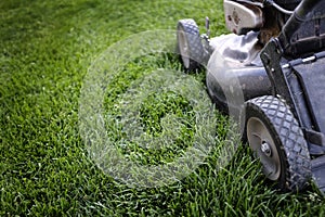 Old Lawn Mower on Lush Green Grass