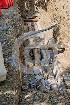 Old leaky pipes in the pit. Preparation for pipe replacement