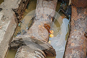 Old leaky pipes in the pit. Preparation for pipe replacement