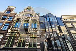 Old leaning house and new modern house in Amsterdam, Netherlands