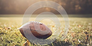 Old leather American football ball on lawn grass closeup