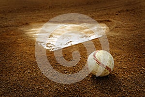 Old Leather Baseball on Field by Home Plate or Base