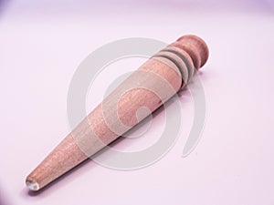 old Leather crafting tool - round wooden Multi-Size Edge Slicker and Burnisher isolated on white background photo