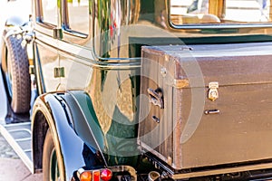 Old leather suitcase on vintage car