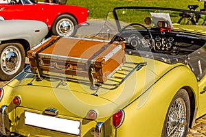 Old leather suitcase on vintage car