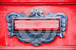 Old letterbox or mailbox in the gate door traditional way of delivering letters or mail to the house address close up