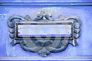 Old letterbox or mailbox in the gate door traditional way of delivering letters or mail to the house address close up