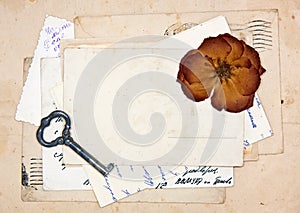 Old letters, empty post cards and dried rose