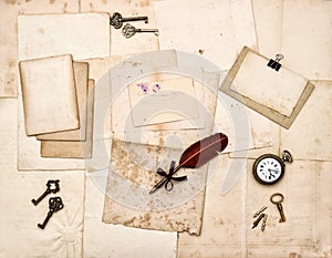 Old letters and photos, vintage keys, antique clock, feather ink