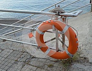 Old lifebuoy on the beach, rescue symbol, help