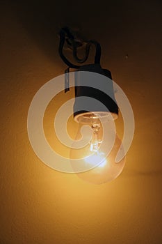 Old light bulb. Old wired light bulb.