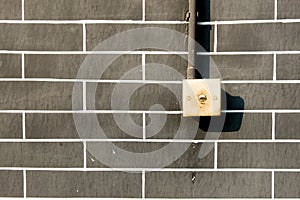 Old light switch on grey brick wall , outddor