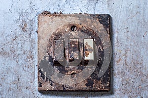 Old light switch mounted on a white wall