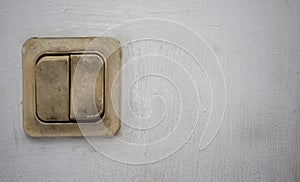 Old light switch on white wall