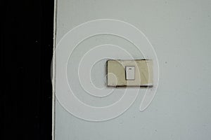 Old light switch on the white wall