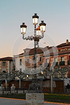 Old lighted lanterns on the background of beautiful buildings and trees