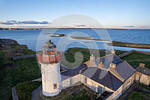 Old lighthouse on Mutton Island, Galway city, Ireland. Aerial view. Beautiful Galway bay in the background. Nature scene with