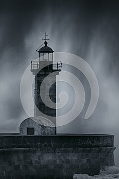 Old lighthouse and spray from stormy waves
