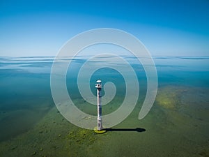 Old lighthouse standing in the sea, aerial view. Estonia, Saaremaa island - Kiipsaare tuletorn.