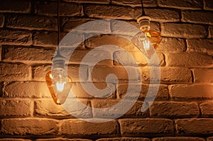 Old lighting electric bulb, Retro lamp on a background of a white brick wall