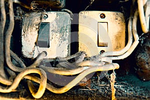 Old Lighting Switch on the wood wall. Close up hand turning on or off on grey light switch with wooden background. Copy space