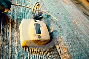 Old Lighting Switch on the wood wall. Close up hand turning on or off on grey light switch with wooden background. Copy space