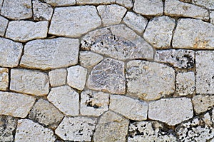 Old limestone wall with irregular shaped blocks