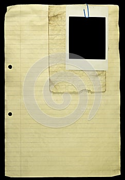 Old Lined paper with paper clip and a polaroid.