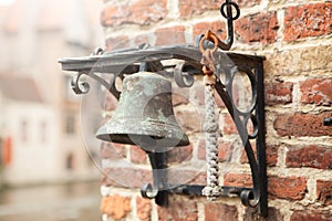 Old little bell on brick wall