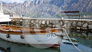 An old little boat slowly moves on the sea in the Bay of Kotor, Montenegro.