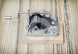 Old little music box on the wooden background, retro style