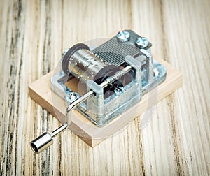 Old little music box on the wooden background, retro style