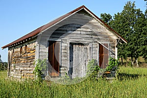 Old little wood building with rusty metal roof