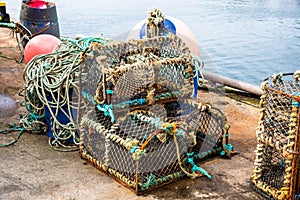 Pile of old lobster traps on a pier