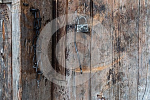 Old lock and chain on an old door. Padlock on the barn. Old doors.