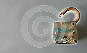 Old Lock with key on Gray background , copy space for text ,unlock