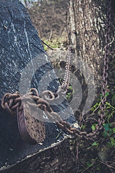 Old lock and rusty chain on a wooden boat