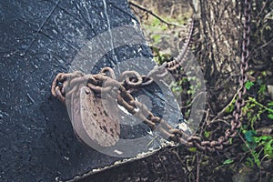 Old lock and rusty chain on a wooden boat