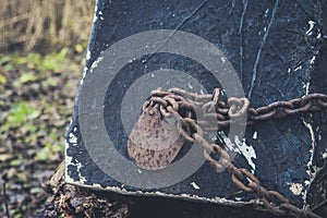 Old lock and rusty chain on a wooden boat