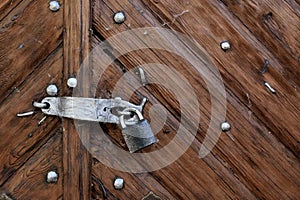 the old lock on the wooden brown door