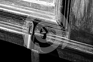 Old lock on a wooden door with rusty closed padlock, Vintage Black and white photo